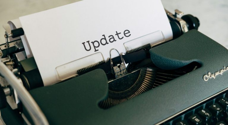 Our Services Overview A close-up of a typewriter with a sheet displaying the word "Update."