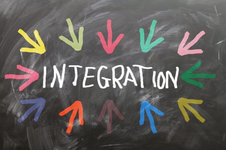 Text "INTEGRATION" surrounded by multi-coloured arrows pointing towards it.