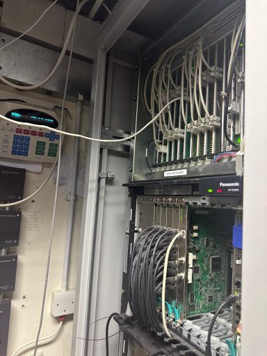 Network server rack with numerous cables and components visible.